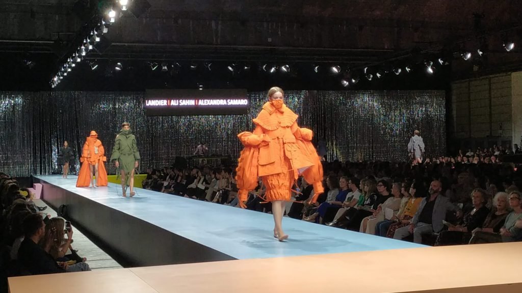 An orange coloured dress presented at ramp of the Royal Academy Fashion show