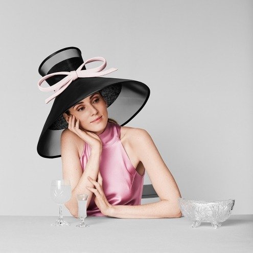 Image of a black hat with pink bow by Lock & Co