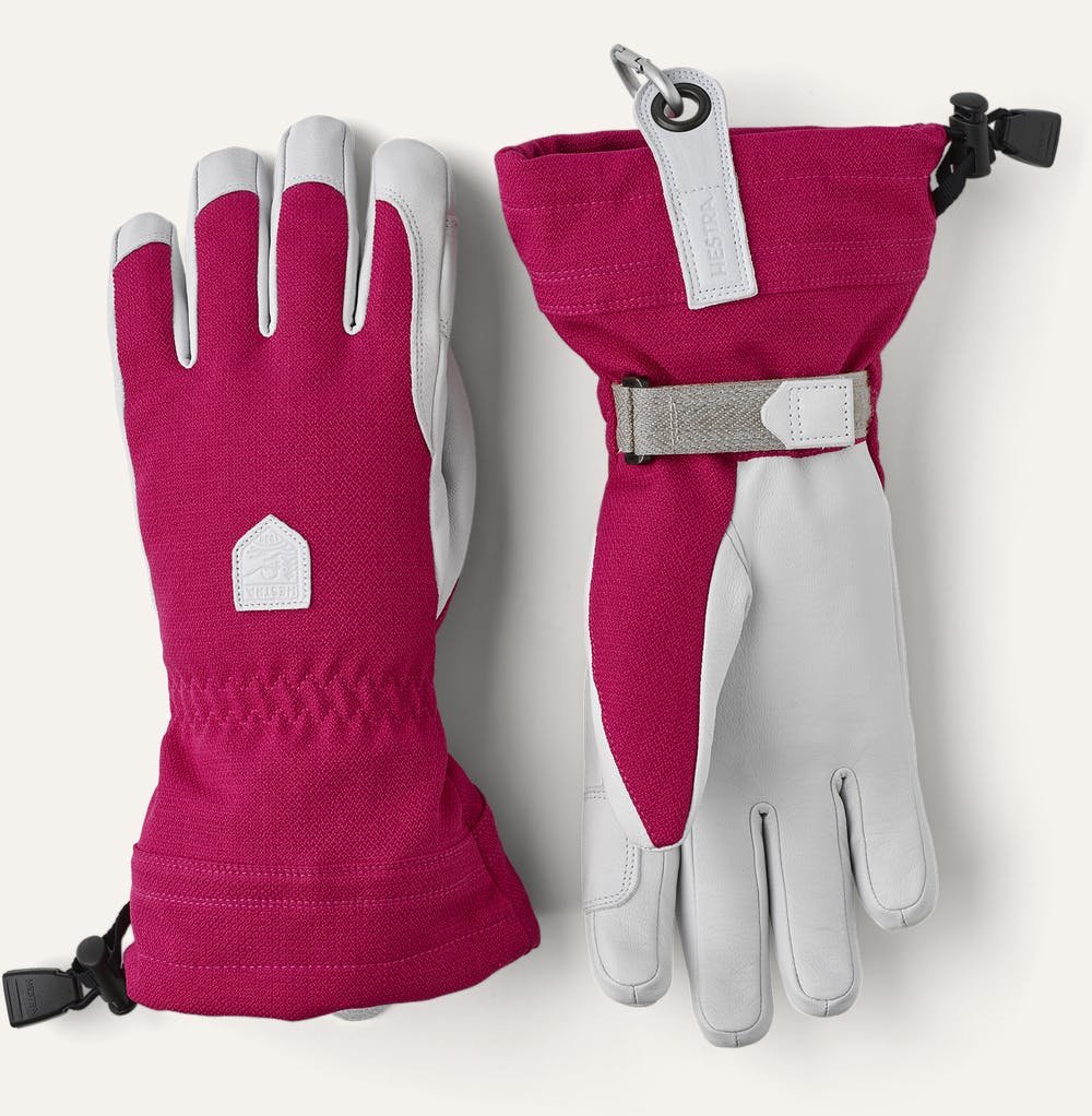 Pink and white gloves which are the striking part of a skiwear