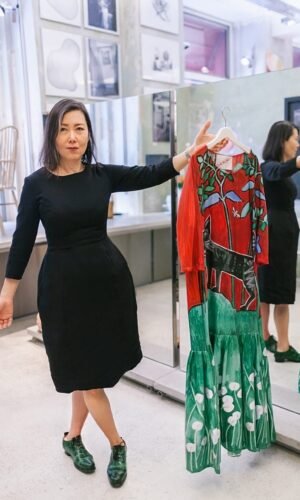 Myung-il+Song+holding+up+a+hand+painted+dress+in+her+store,+Song,+in+Vienna_