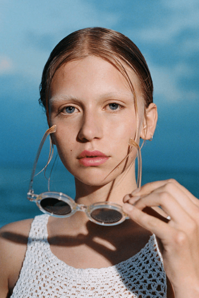 DELARGE sunglasses on woman at beach.