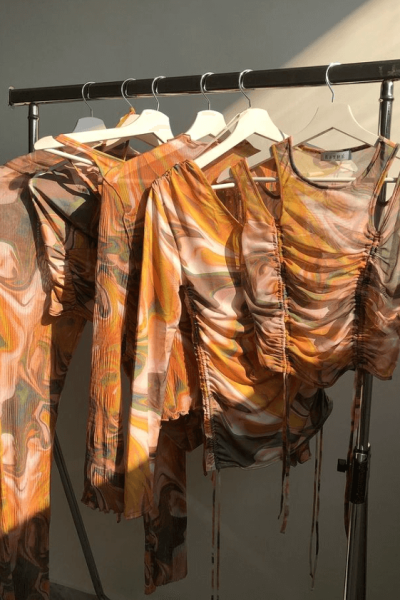 ESTHÉ garments on hangers.